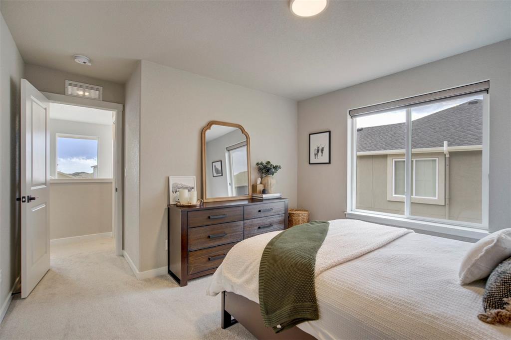 Image 27 of 43: Bedroom with light colored carpet and baseboards