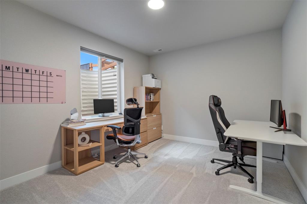 Image 35 of 43: Home office featuring light colored carpet and baseboards