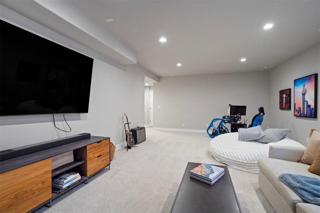 Image 36 of 43: Living room with light carpet and recessed lighting