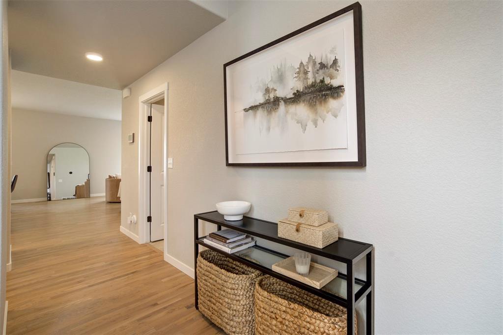 Image 5 of 43: Corridor featuring arched walkways, light wood-style floors, and recessed l
