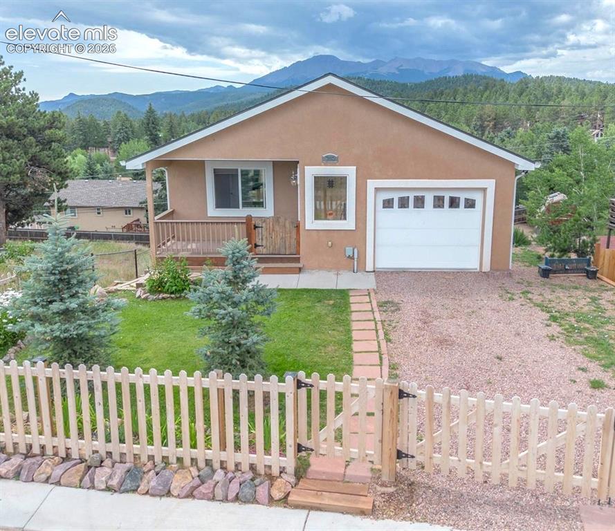 Caption: Enjoy incredible mountain views from this charming Woodland Park home, ideally located within walkin
