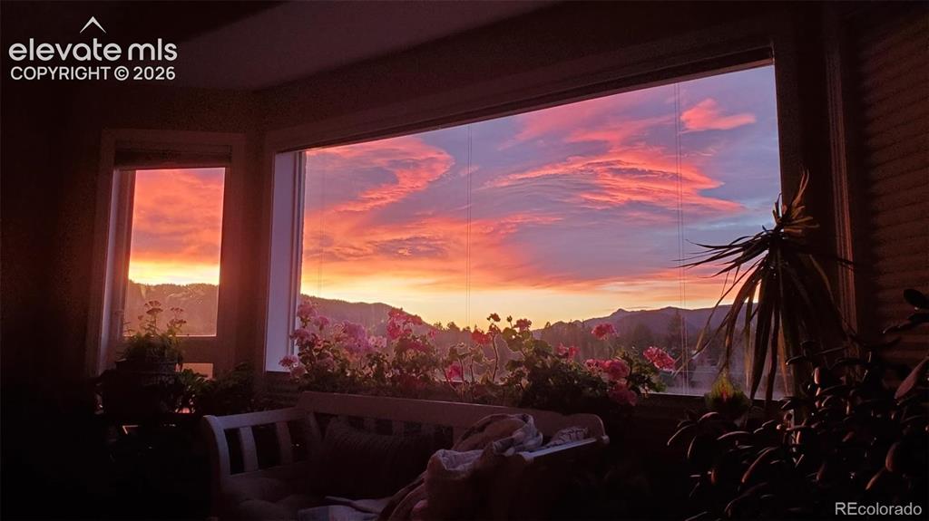 Image 10 of 45: Expansive window framing a mountain backdrop