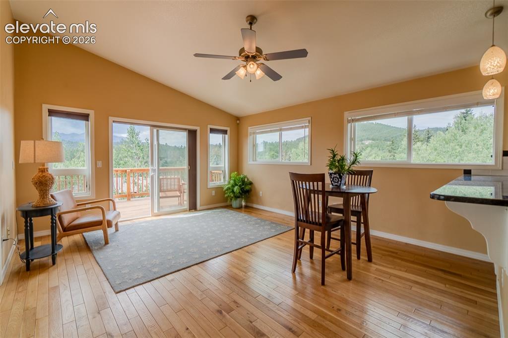 Image 17 of 41: Comfortable family room with oversized windows showcasing the surrounding s