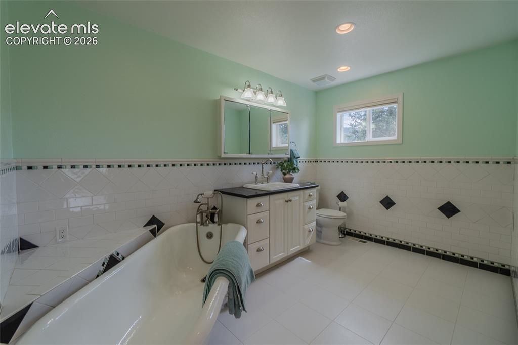 Image 25 of 41: Spacious primary bathroom featuring a relaxing soaking tub, separate shower