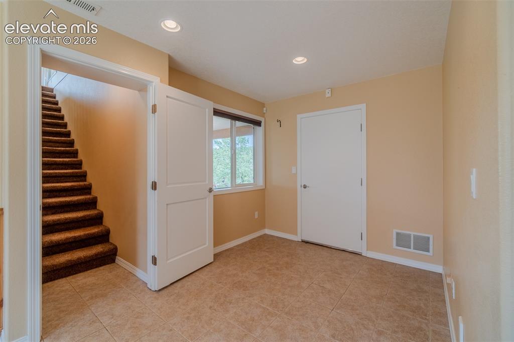 Image 28 of 41: Inviting basement bedroom with nearby 3/4 bathroom, perfect for guests, fam