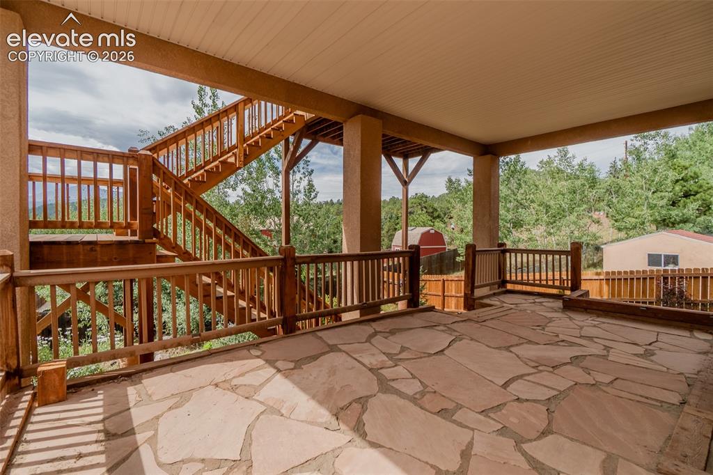 Image 32 of 41: Exceptional outdoor living with multiple covered flagstone patios, creating