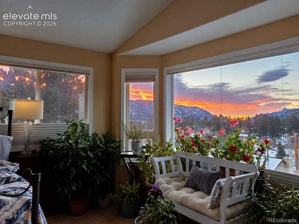 Image 4 of 45: Expansive windows with mountain scenery, angled ceiling details, and neutra