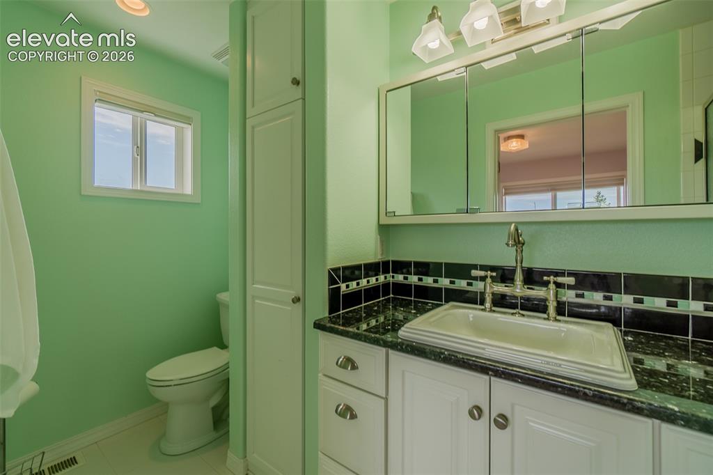 Image 7 of 41: The secondary bedroom features its own attached bathroom with a walk-in sho
