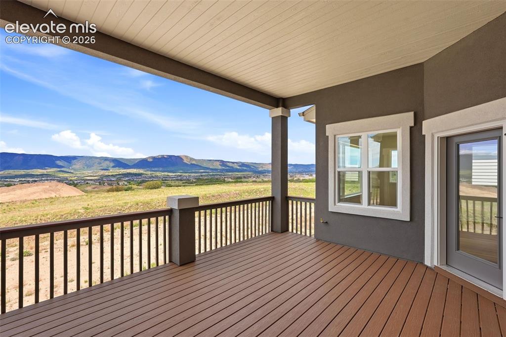 Image 12 of 50: Spacious Covered Rear Deck with Western exposure for to enjoy those Colorad