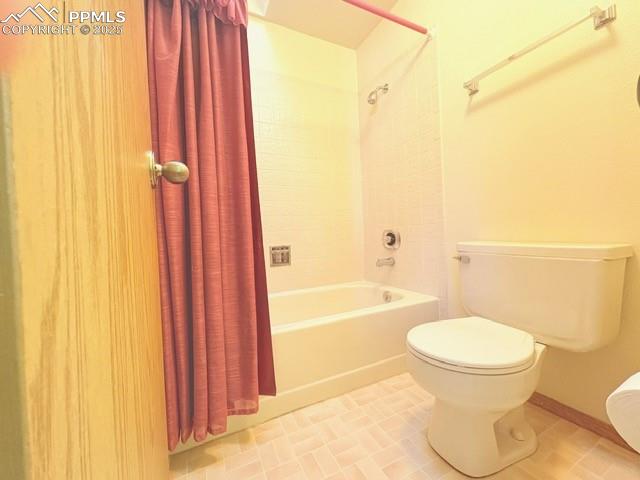 Image 11 of 18: Bathroom featuring shower / bath combo and light tile patterned floors