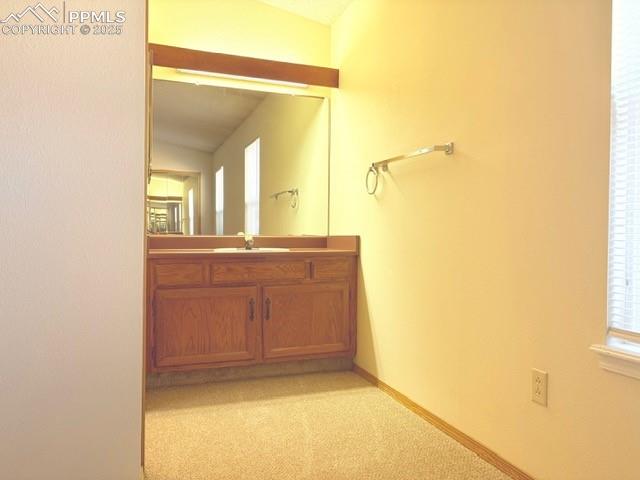 Image 11 of 28: Bathroom featuring vanity and light carpet