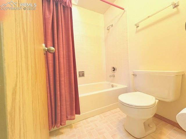 Image 12 of 28: Bathroom featuring shower / bath combo and light tile patterned floors