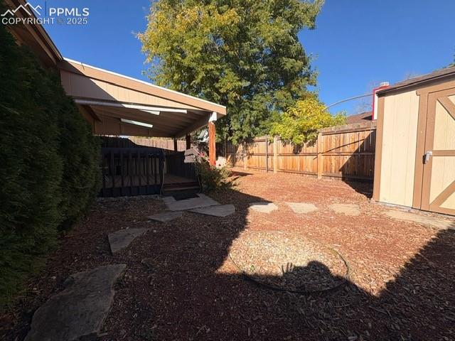 Image 15 of 28: View of yard featuring a deck and a storage shed