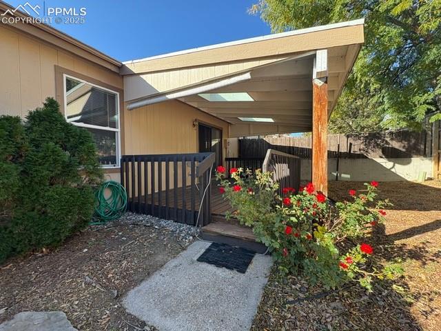 Image 16 of 28: Entrance to property with a wooden deck