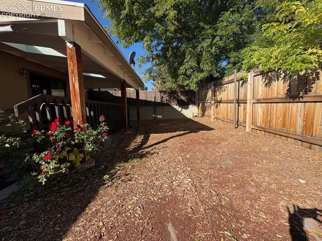 Image 18 of 28: View of fenced backyard