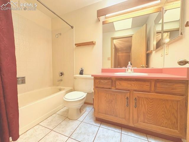 Image 6 of 28: Full bathroom with vanity, light tile patterned floors, and shower / tub co