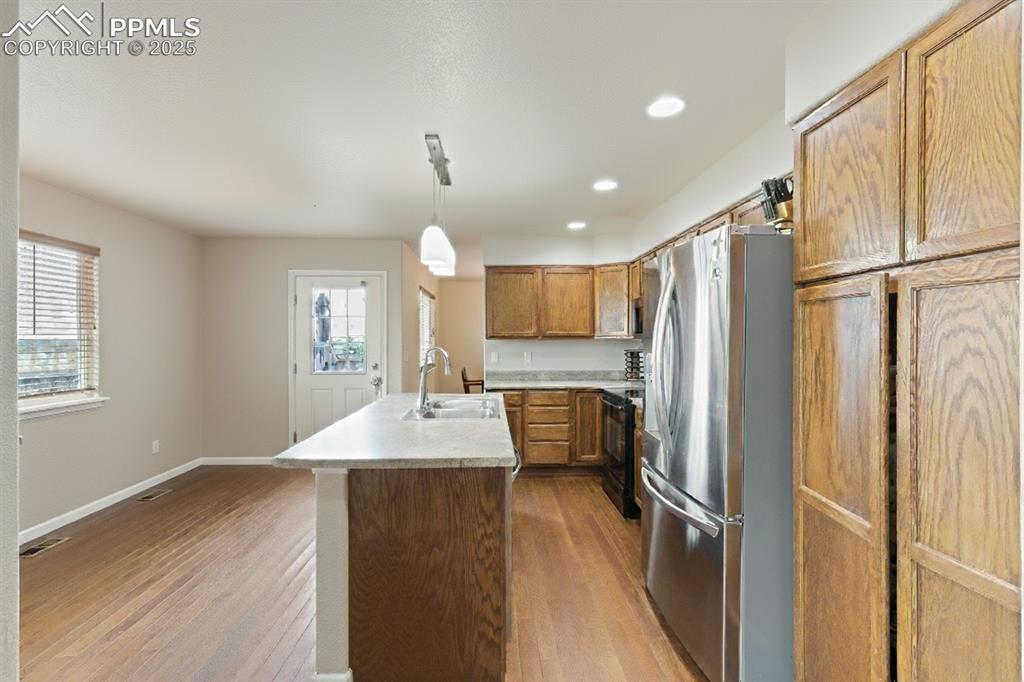 Image 12 of 41: Kitchen featuring freestanding refrigerator, recessed lighting, light count