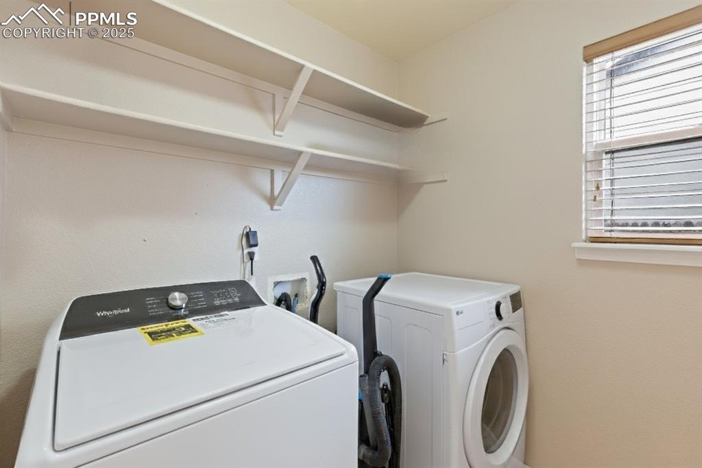Image 19 of 41: Washroom featuring washer and clothes dryer