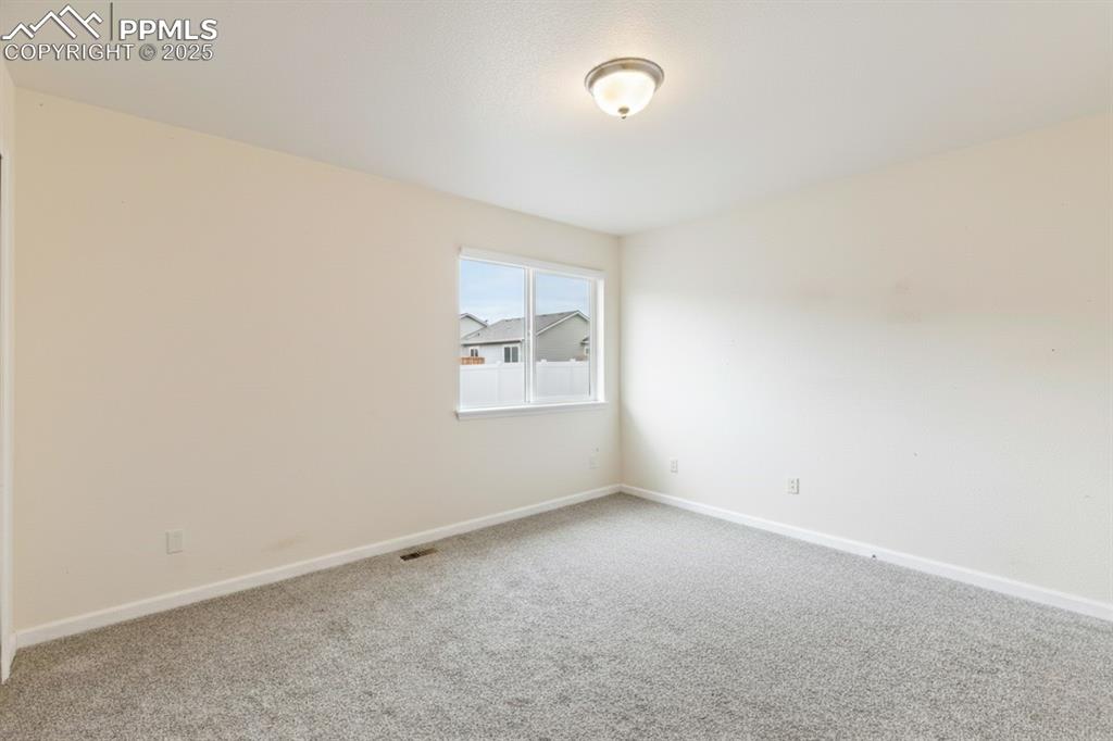 Image 24 of 41: Carpeted spare room featuring baseboards