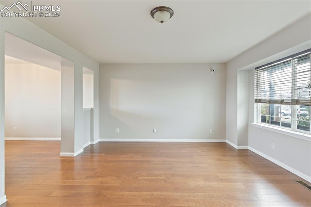 Image 5 of 41: Spare room featuring light wood finished floors and baseboards