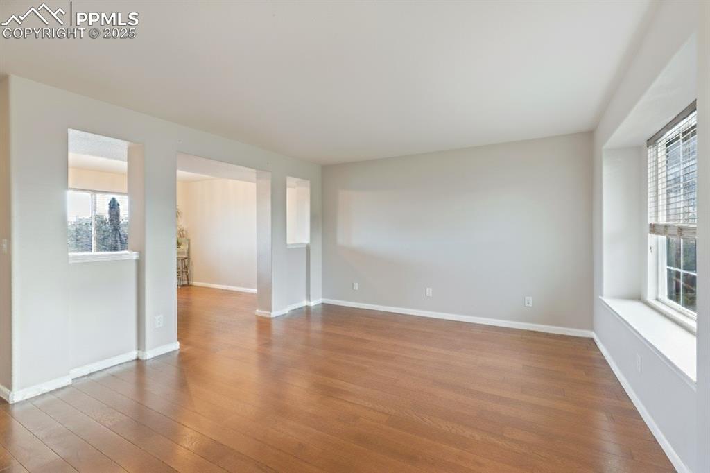Image 6 of 41: Empty room featuring baseboards and wood finished floors