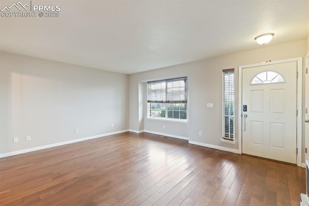 Image 7 of 41: Foyer entrance featuring baseboards and hardwood / wood-style flooring