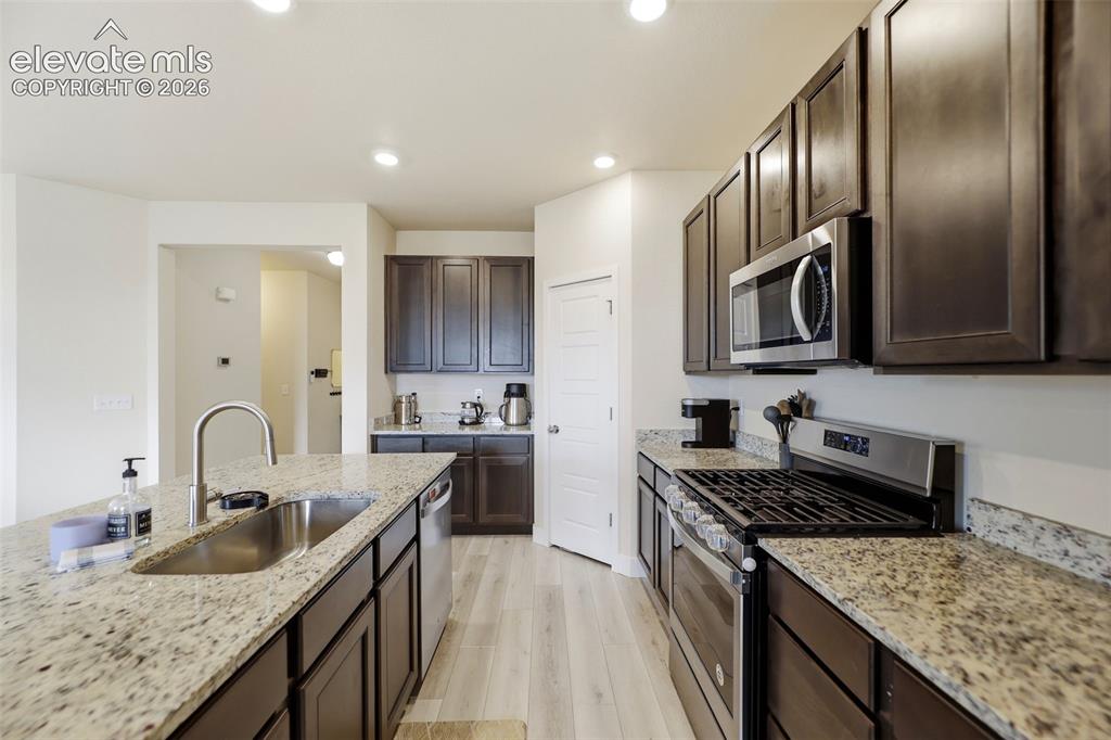 Image 10 of 49: Enjoy the countertop seating and open feel of the kitchen space.