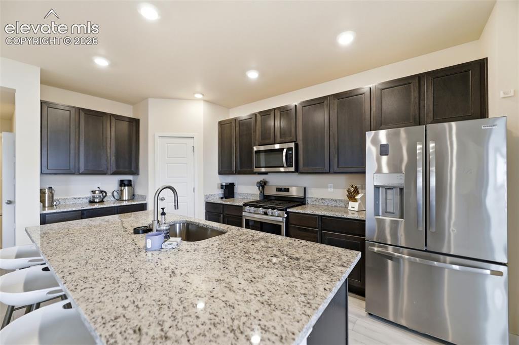 Image 7 of 49: Beautiful granite countertops and contemporary cabinets accent the kitchen.
