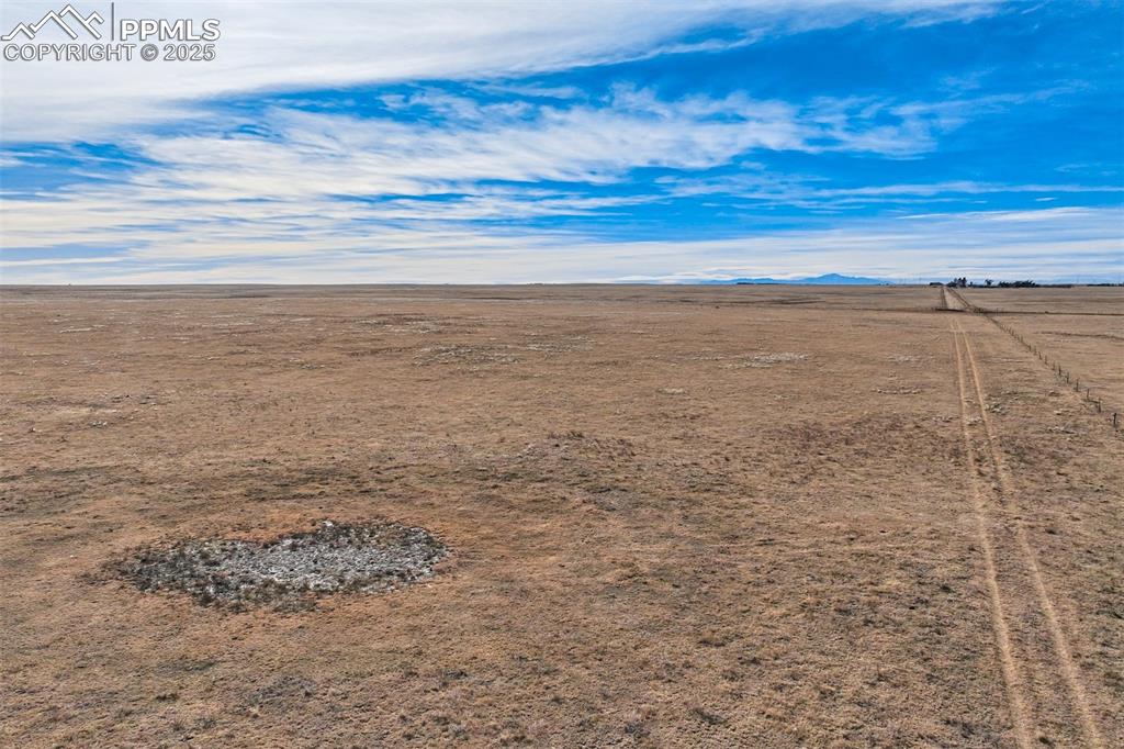 Image 28 of 30: Aerial view of sparsely populated area featuring a mountain backdrop