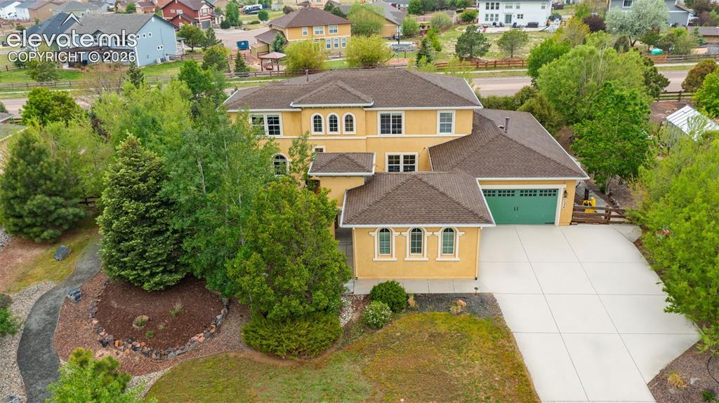 Image 1 of 45: Multi-story exterior with stucco finish, arched windows, attached garage wi