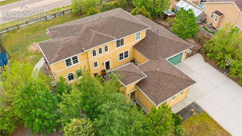 Image 30 of 45: Multi-story residence featuring a stucco exterior and a hip roofline