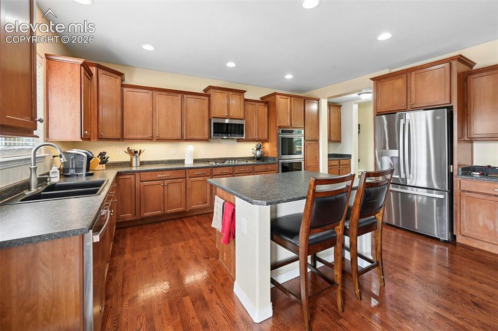 Image 7 of 37: Stanless steel appliances and wood floors