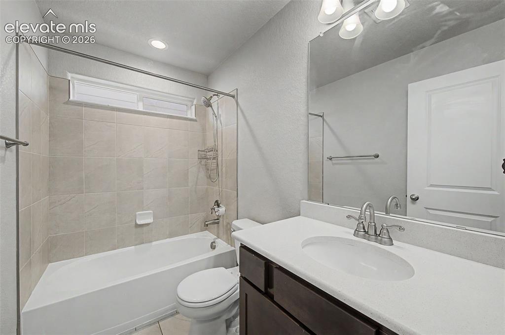 Image 29 of 44: Bathroom featuring a white bathtub, tiled shower surround, horizontal trans