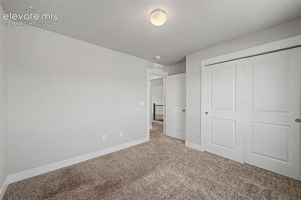 Image 30 of 44: Bedroom featuring plush carpet flooring, a flush-mount ceiling light, white