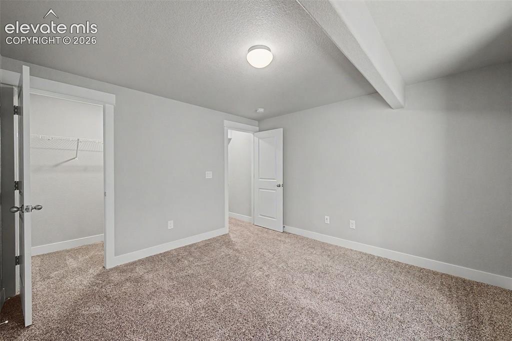 Image 36 of 44: Neutral-toned wall-to-wall carpeting complements light gray wall finishes a