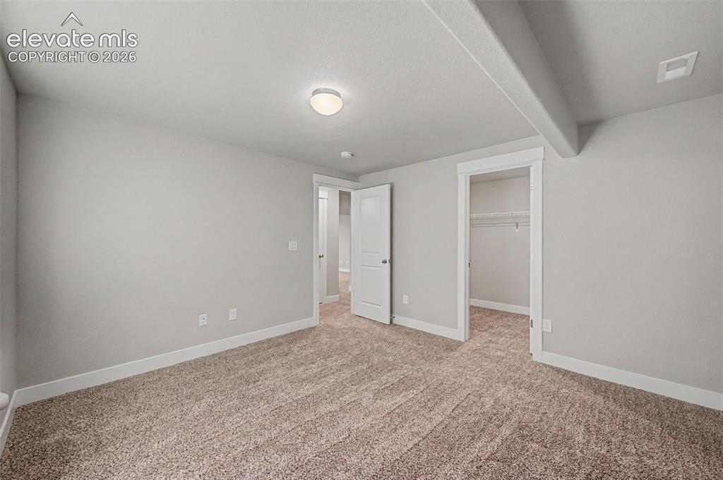 Image 39 of 44: Carpeted room featuring light gray walls, white baseboards, and a flush-mou