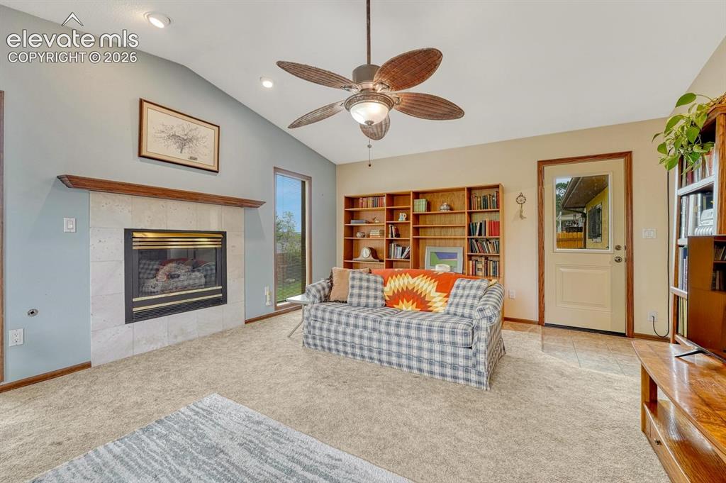 Image 10 of 48: Family room is a cozy second living space featuring gas fireplace, vaulted 