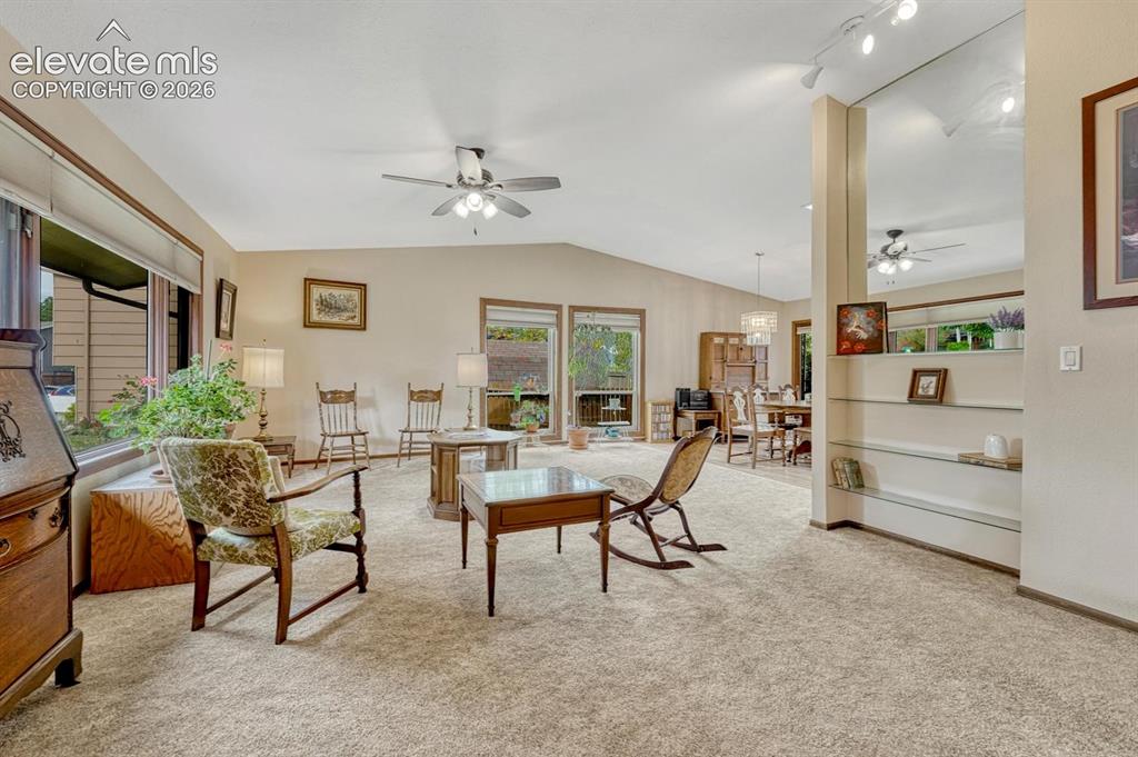 Image 7 of 48: Big living room with vaulted ceiling is an impressive gathering space.