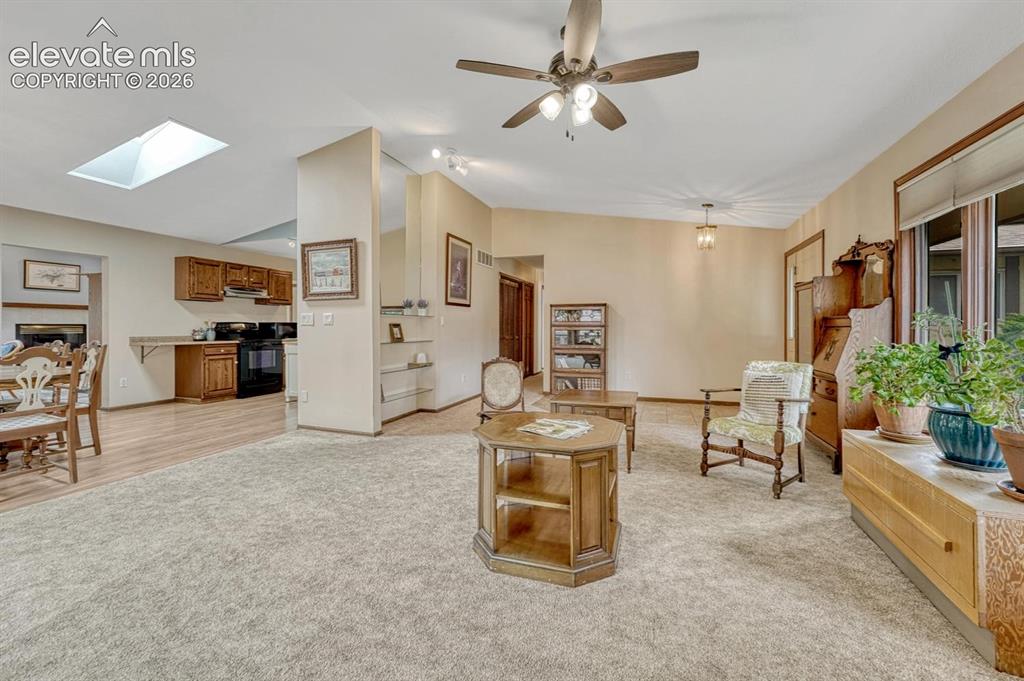 Image 8 of 48: Living room opens to the dining room.