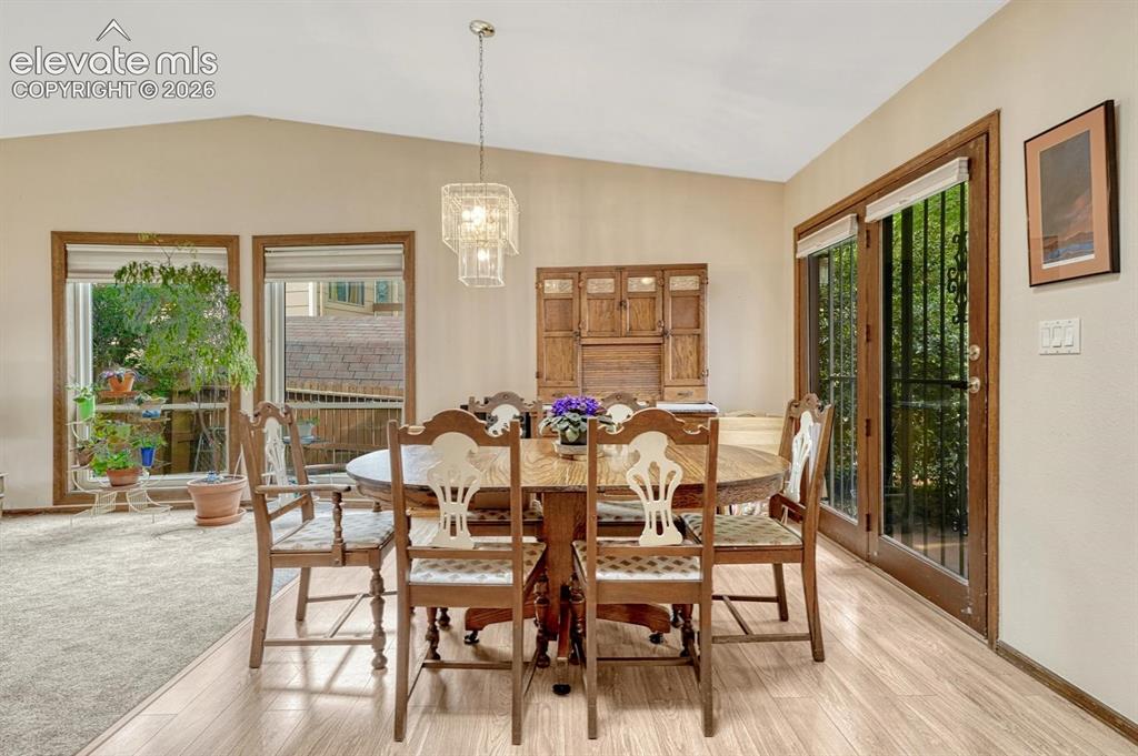 Image 9 of 48: Dining room with skylights walks out to the side patio.