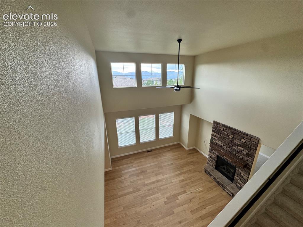 Image 16 of 42: Views from the catwalk overlooking the Great Room with gas fireplace and st