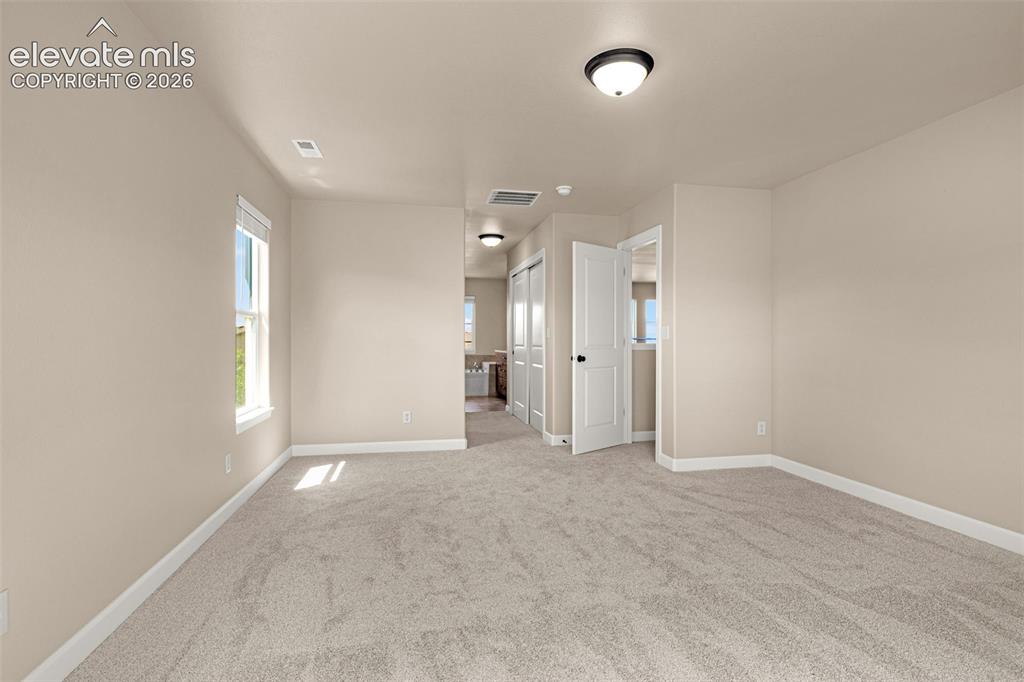 Image 19 of 42: Expansive Primary has his-and-her closets; one a walk-in.