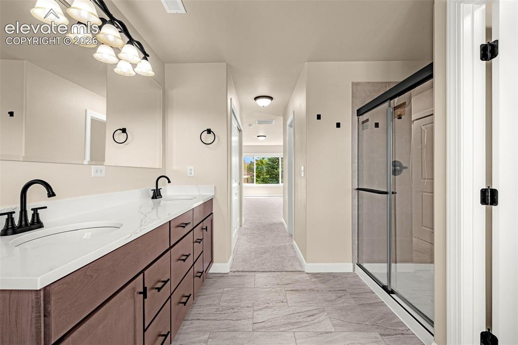 Image 22 of 42: View of the updated Primary Bathroom with new flooring, large walk-in showe
