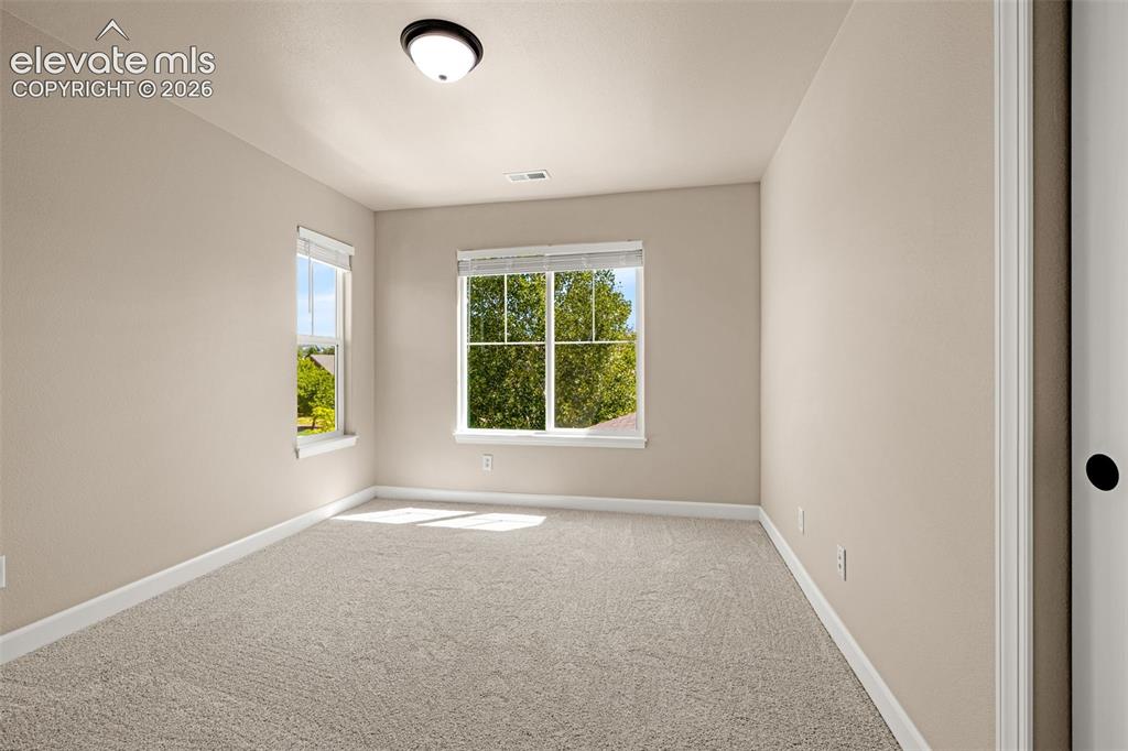Image 25 of 42: 2nd Upper level bedroom has lots of light, new flooring, baseboards, blinds