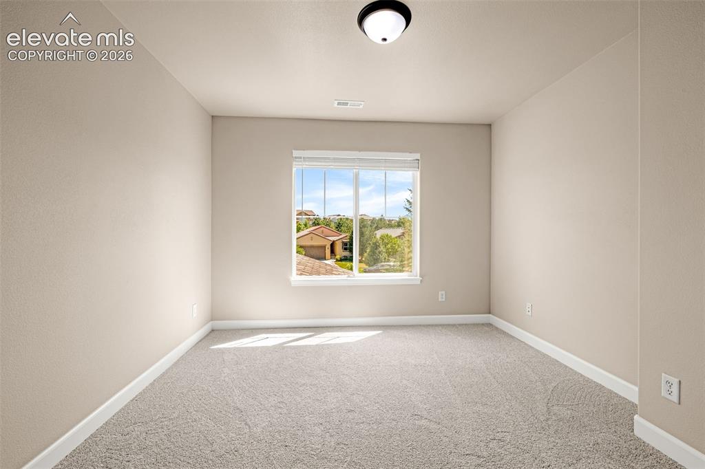 Image 27 of 42: 4th Upper level bedroom with new carpet, blinds, lights and walk-in closet.