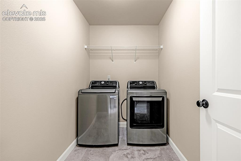 Image 28 of 42: Perfectly located on the Upper level a large laundry area with washer and d