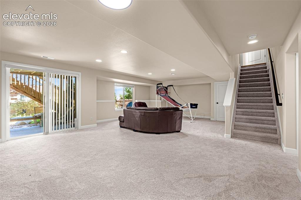 Image 29 of 42: Walk-out Family Room offers a great space for guests or family. Large area