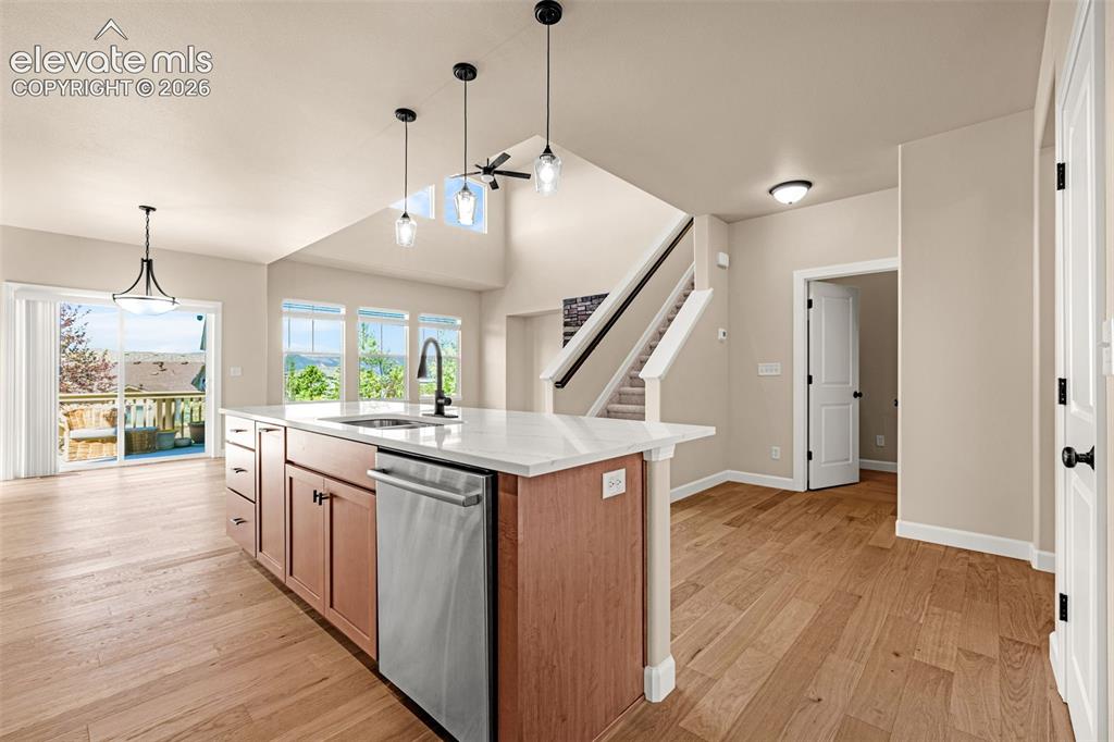 Image 5 of 42: View of the Kitchen open to the Great Room and walk-out dining area.