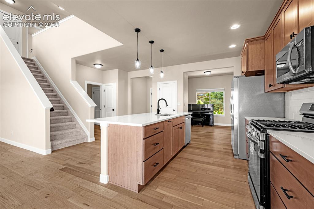 Image 6 of 42: Another view of the Kitchen with view of the front entry, coat closet and O
