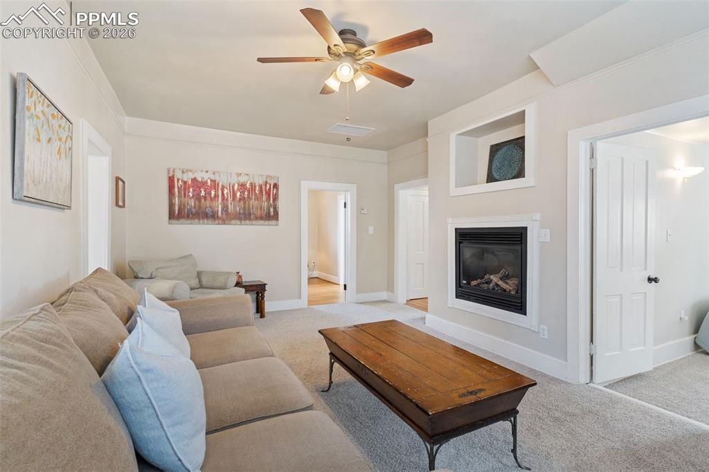 Image 13 of 36: Light and bright living room with gas fireplace; new carpet and pad just in